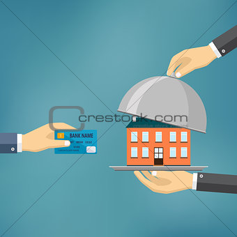 Hands holding credit card and cloche with house.