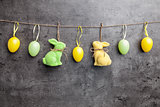 Easter eggs and bunnies on hanging on rustic background