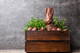 Traditional Easter chocolate bunny and eggs inside a wooden crate