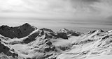 Black and white panorama of Caucasus Mountains in snow winter ev