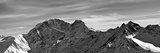 Black and white panorama on winter snow mountains