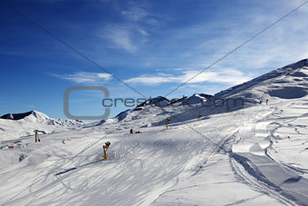 Ski slope with snowmaking at sun morning