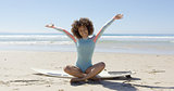 Woman on surfboard with hands up