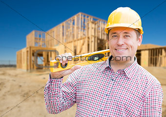 Smiling Male Contractor in Hardhat Holding Blueprints  and Level