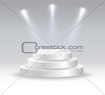 Round podium illuminated by spotlights.
