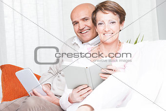 Loving happy couple relaxing reading at home