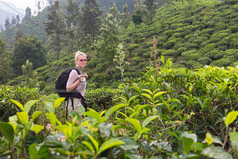 Female tourist enjoying beautiful nature of tea plantations, Sri Lanka.