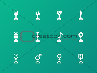 Sports trophies and awards icons on green background.
