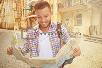 Young hipster man with map