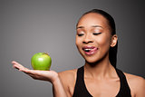 Happy healthy black asian woman with delicious apple