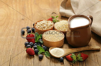 Set of different cereals for porridge with milk and berries