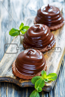 Individual cakes with souffle in chocolate glaze.