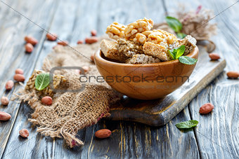 Wooden bowl with mint and honey bars with nuts and seeds.