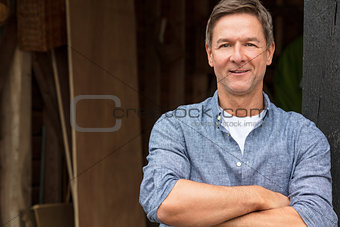 Happy Middle Aged Man Arms Folded by His Garage