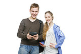 Teen boy and girl standing with mobile phones