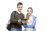 Teen boy and girl standing with mobile phones
