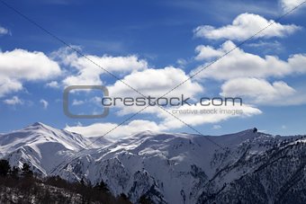 Sunlight snow mountains and blue sky with clouds