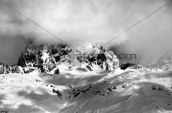Black and white view on Mount Ushba in fog at sun winter day