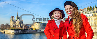 mother and child tourists on embankment near Notre Dame de Paris