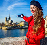 traveller woman in Paris taking photo with smartphone