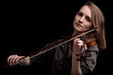 tattooed violinist woman playing in black background