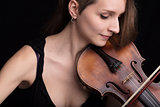 beautiful woman playing violin studio portrait on black