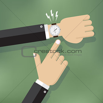 Hand pointing at watch.