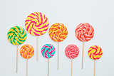 Lollipop candy caramel on sticks on white