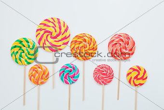 Lollipop candy caramel on sticks on white