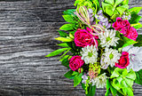 wedding bouquet with roses and white gerberas on an old wooden t