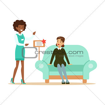 Store Seller Showing Blue Sofa To Woman, Smiling Shopper In Furniture Shop Shopping For House Decor Elements