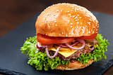 Hamburger on stone table with black background. Fastfood meal. Delicious Hamburger. Gourmet hamburger.