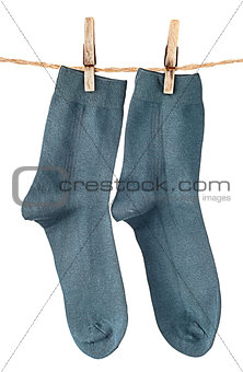 Dark blue socks on rope with clothespins