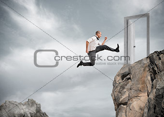 Businessman jumping over the mountains to reach a door