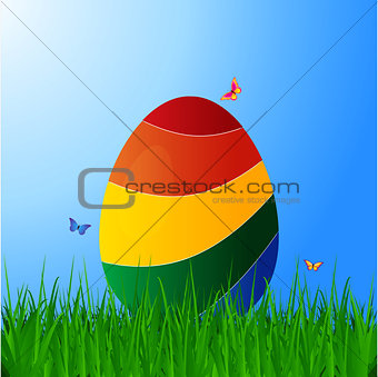 Curved striped Easter egg on grass over blue sky
