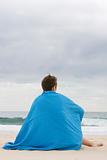 woman with blue blanket on beach