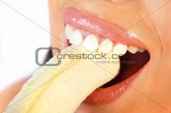 woman with perfect teeth eating a banana