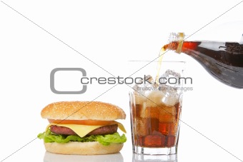 Cheeseburger and pouring soda