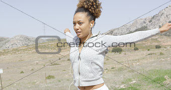 Pretty young woman working out in nature