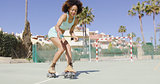 Young pretty woman riding in roller skates