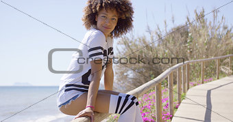 Smiling woman sitting on railings