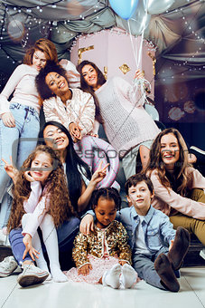Lifestyle and people concept: young pretty diversity nations woman with different age children celebrating on birth day party together happy smiling, making selfie. African-american, asian and caucasian