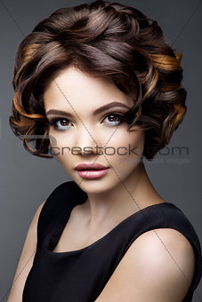 Make up. Glamour portrait of beautiful woman model with fresh makeup and romantic wavy hairstyle.