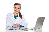 Young female student doctor sitting with a laptop on a white background