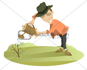 Smiling man watering a tree
