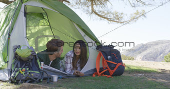 Young couple lying in tent