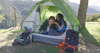 Smiling couple having fun in tent