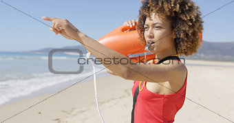 Lifeguard blowing a whistle on beach