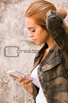 girl plugged into her mobile phone
