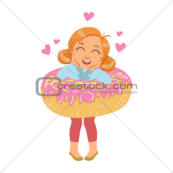 Little girl laughing and standing inside a big pink donut, a colorful character